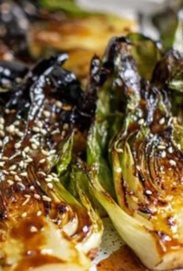 Sautéed bok choy in a skillet, showcasing its vibrant green color and fresh texture.