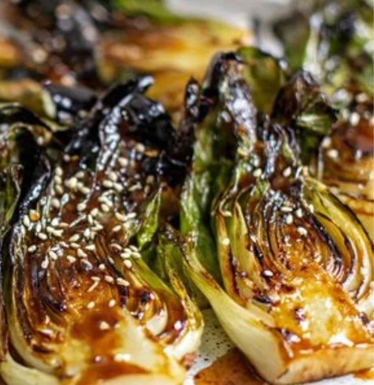 Sautéed bok choy in a skillet, showcasing its vibrant green color and fresh texture.