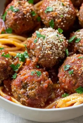 Delicious baked Italian meatballs served with marinara sauce on a plate.