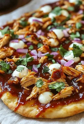 Delicious BBQ chicken pizza on flatbread with fresh ingredients and BBQ sauce.