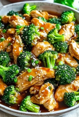 Plate of Chinese Chicken and Broccoli with vibrant vegetables and sauce