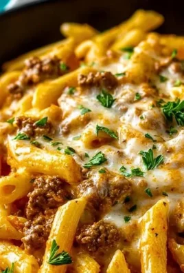 Creamy high protein beef pasta dish with rich sauce and garnished herbs
