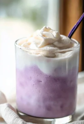 Homemade lavender cold foam in a glass cup, perfect for coffee or dessert toppings.
