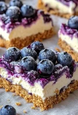 No-bake blueberry cheesecake bars topped with fresh blueberries