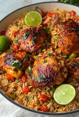 Plate of spicy peri peri chicken served with rice and garnished with fresh herbs.