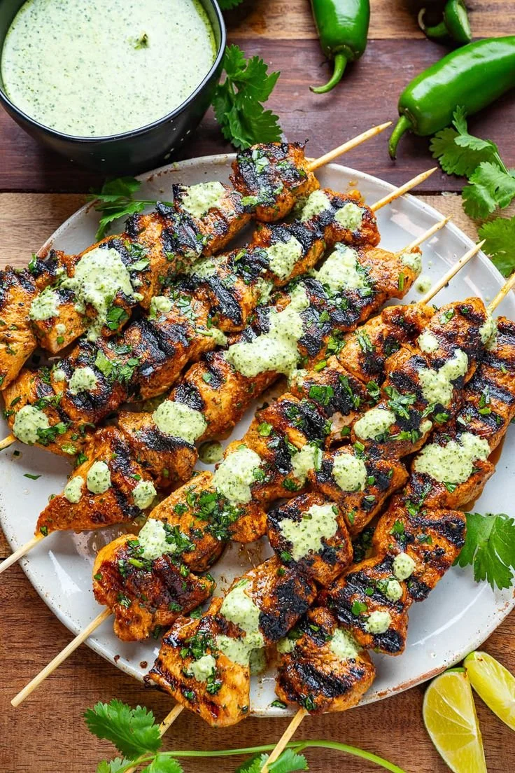 Delicious Peruvian grilled chicken skewers served with dipping sauce