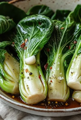 Sautéed bok choy dish served on a plate with garlic and sesame seeds