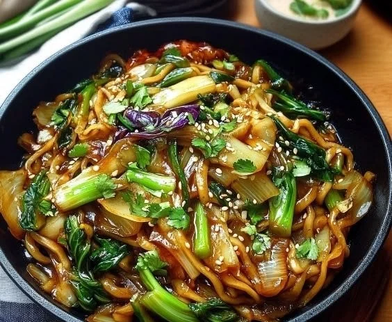 Sautéed Bok Choy Lo Mein with ginger and vegetables in a bowl