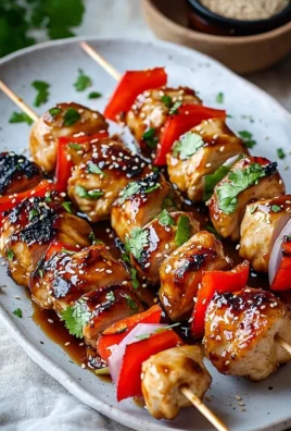 Smoky BBQ chicken skewers with honey glaze on a grill