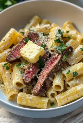 Delicious Steak Pasta with Creamy Garlic Parmesan Sauce served in a bowl.