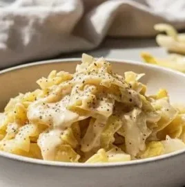 Plate of creamy Alfredo Cabbage with garnishes