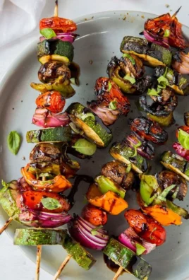 Colorful plate of balsamic grilled vegetables - bell peppers, zucchini, and carrots.