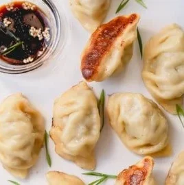Delicious homemade beef dumplings served with dipping sauce.