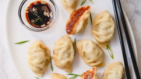 Delicious homemade beef dumplings served with dipping sauce.