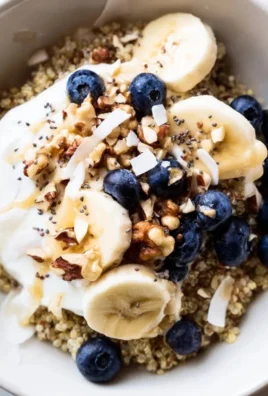 Healthy blueberry quinoa breakfast bowl topped with fresh berries and nuts