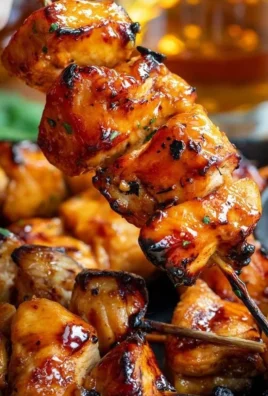 Bourbon Chicken Skewers ready to be grilled with a delicious glaze.
