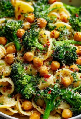 Bowl of broccoli chickpea pasta drizzled with garlic olive oil