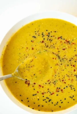 Bowl of Broccoli Red Lentil Detox Soup garnished with herbs