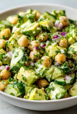 Chickpea avocado cucumber salad with lemon dressing in a bowl