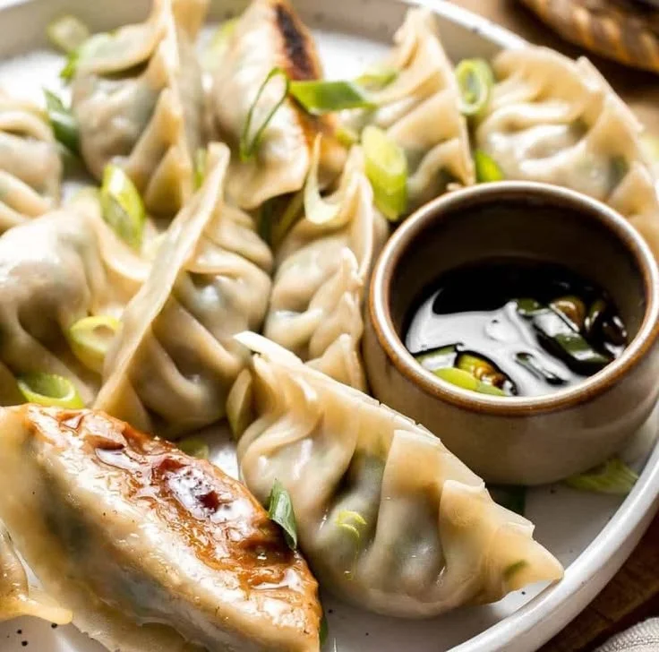 Chinese beef dumplings filled with celery served on a plate.