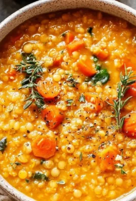 Cozy anti-inflammatory lentil soup in a bowl, garnished with herbs.