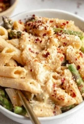 Creamy dairy-free lemon white bean pasta served in a bowl with fresh herbs.