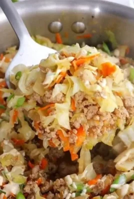 Healthy egg roll in a bowl with fresh vegetables and savory sauce