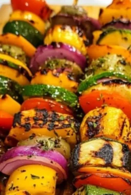 Colorful grilled vegetable kabobs on skewers with bell peppers, zucchini, and mushrooms