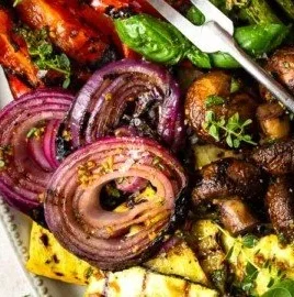 Grilled seasonal vegetables with zesty balsamic marinade on a platter