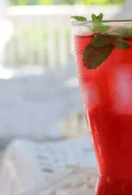Homemade lacto-fermented raspberry soda in a glass with fresh raspberries