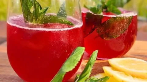 Homemade naturally carbonated hibiscus soda served in a glass with ice