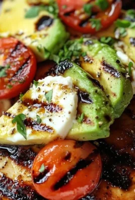 Juicy Grilled California Avocado Chicken served on a plate with fresh herbs