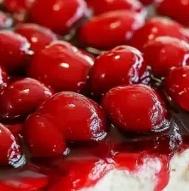 No bake cherry cheesecake dessert topped with cherry filling and whipped cream