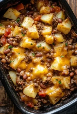 Delicious slow cooker cowboy casserole served in a bowl with toppings.