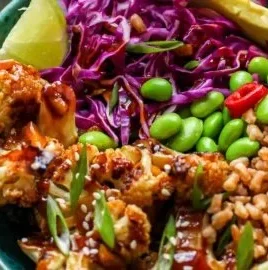 Teriyaki cauliflower power bowls with colorful vegetables and sauce