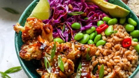 Teriyaki cauliflower power bowls with colorful vegetables and sauce