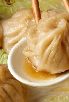 Delicious soup dumplings served in a bamboo basket, perfect comfort food.