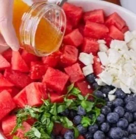 Delicious watermelon salad with blueberries and feta cheese in a bowl