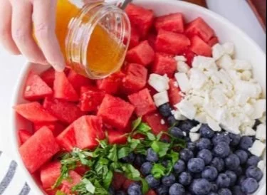 Delicious watermelon salad with blueberries and feta cheese in a bowl