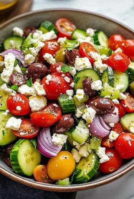 Delicious Greek salad with fresh cucumbers, tomatoes, olives, and feta cheese