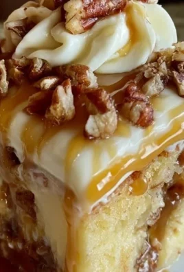 Delicious Butter Pecan Poke Cake topped with praline and nuts