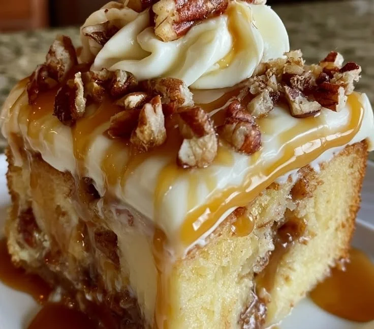 Delicious Butter Pecan Poke Cake topped with praline and nuts