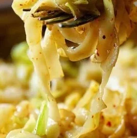 Delicious plate of cabbage and noodles garnished with herbs