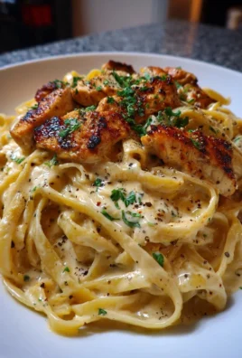 Creamy Cajun chicken alfredo dish garnished with herbs on a plate