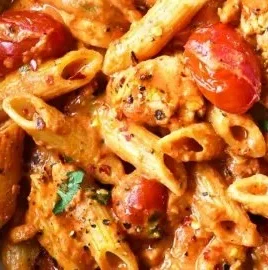 Creamy chicken in spicy tomato sauce served with fresh herbs