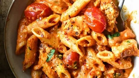 Creamy chicken in spicy tomato sauce served with fresh herbs