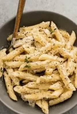 Creamy Garlic Chicken Penne served with a sprinkle of parsley.