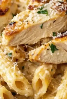 Delicious creamy garlic parmesan chicken served over pasta
