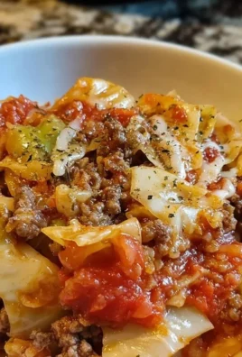 Delicious Crockpot Cabbage Roll Casserole served in a bowl with fresh herbs.