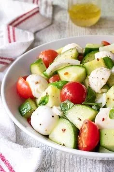 Cucumber Caprese Salad with fresh cucumbers, ripe tomatoes, and mozzarella cheese.